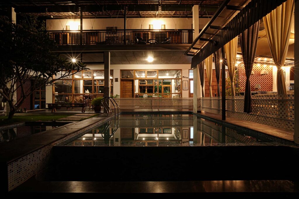 Exterior view of a luxury boutique estate villa surrounded by lush greenery in Wayanad, Kerala.